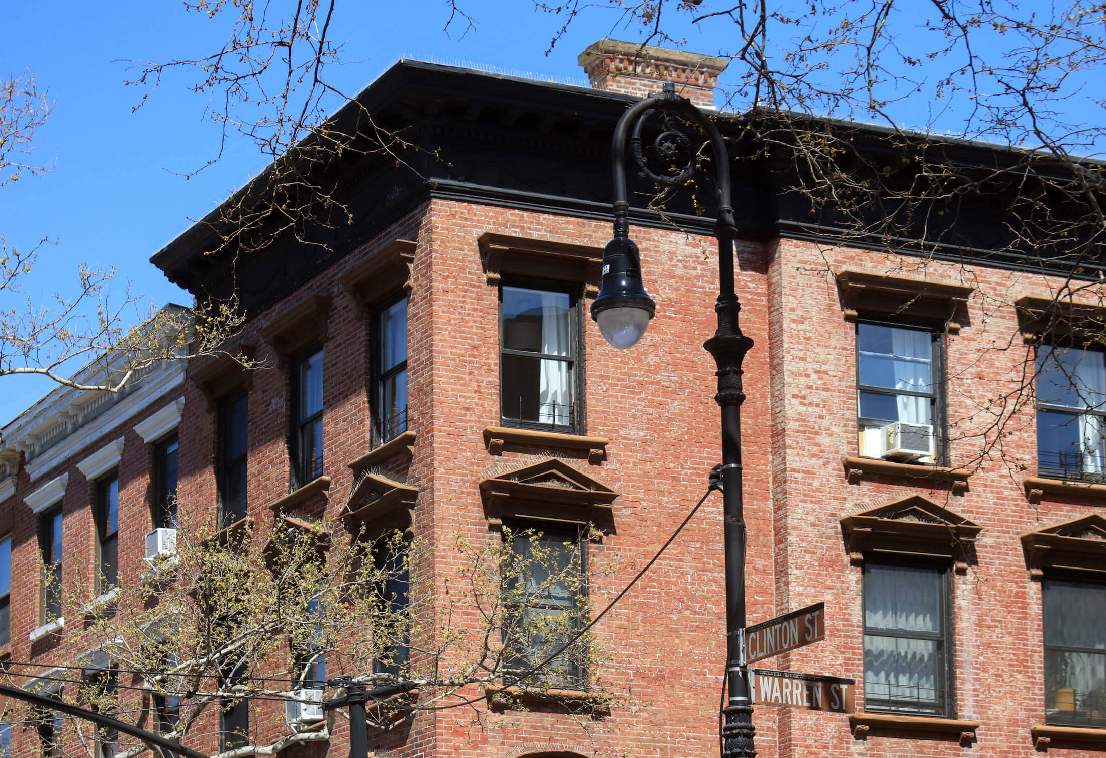 cornices on clinton and warren streets with historic district street signs