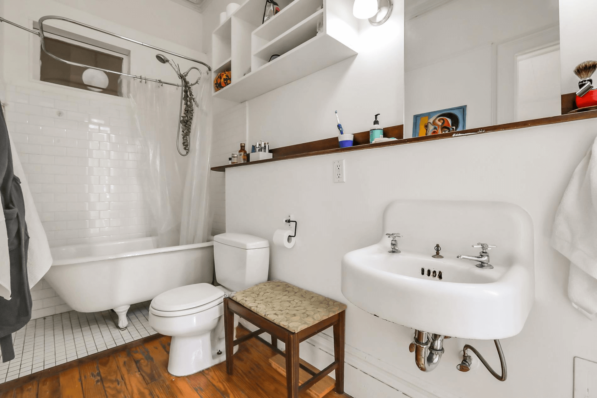 bathroom with claw foot tub and vintage sink