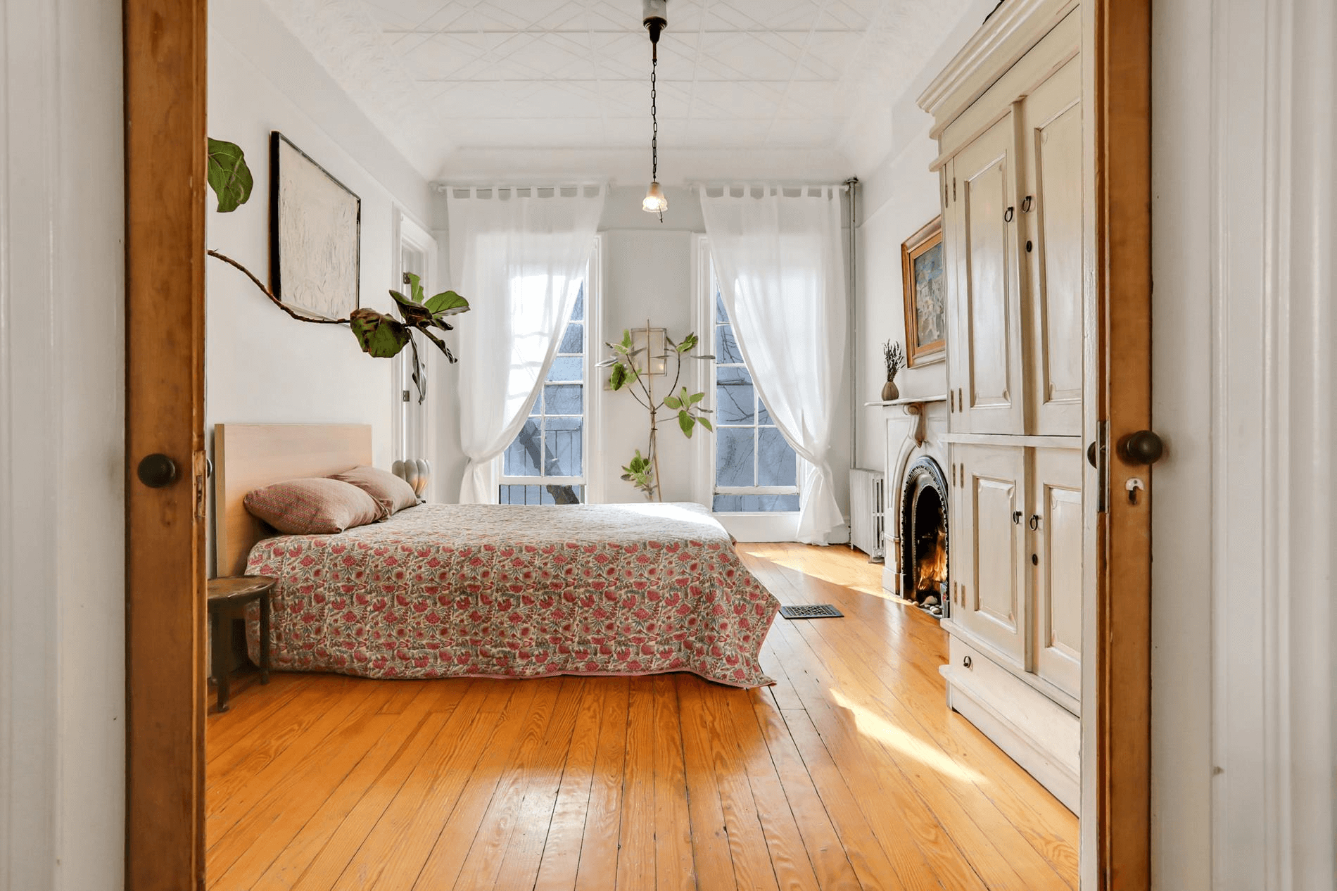 bedroom with tin ceiling and marble mantel