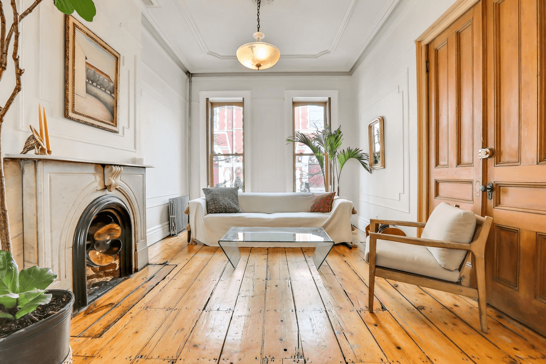 living room with marble mantel and wood floors