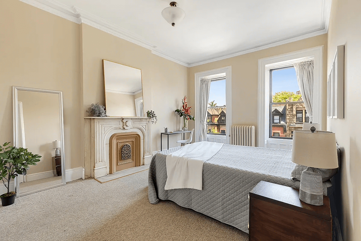 bedroom with carpet and mantel