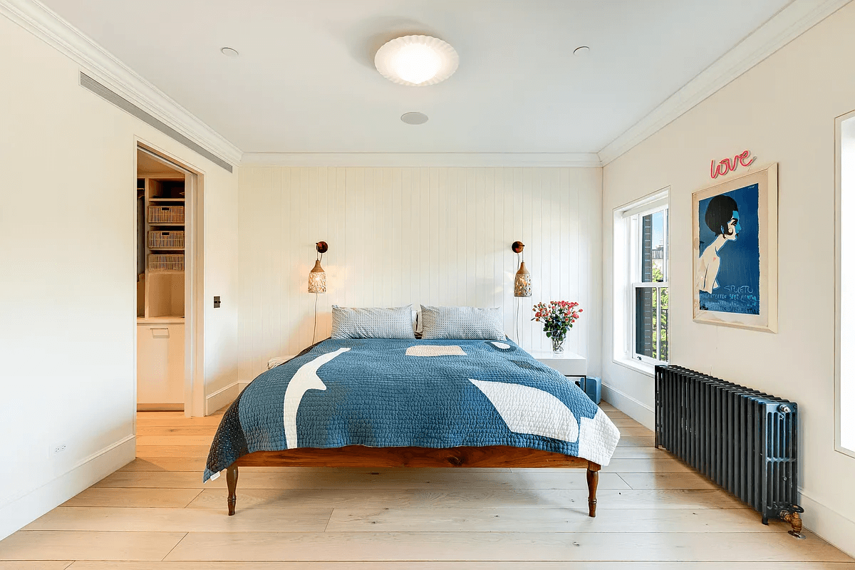 bedroom with paneling on one wall