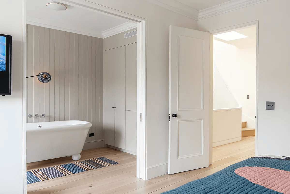 bedroom with ensuite bath with soaking tub