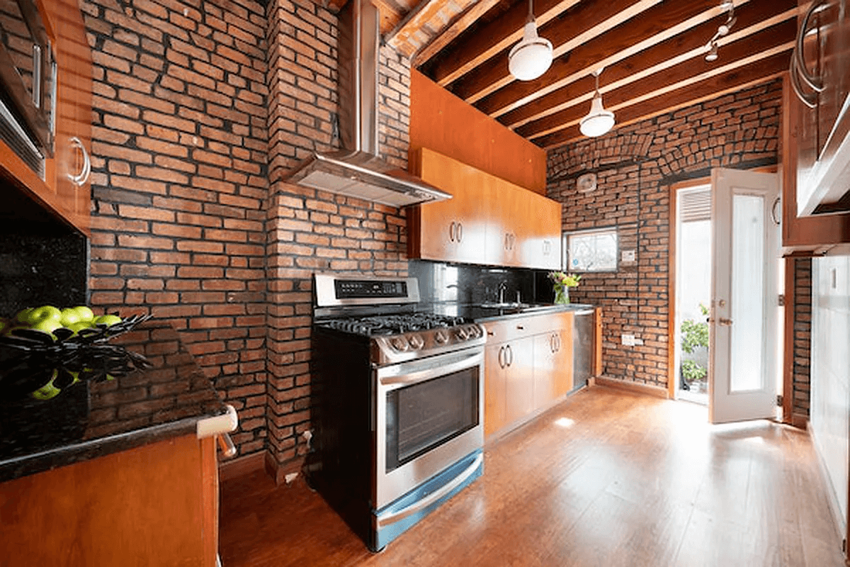 kitchen with brick walls and exposed beams