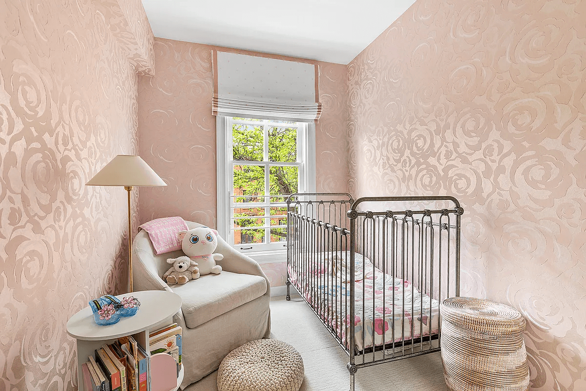 small nursery with pink wallpaper