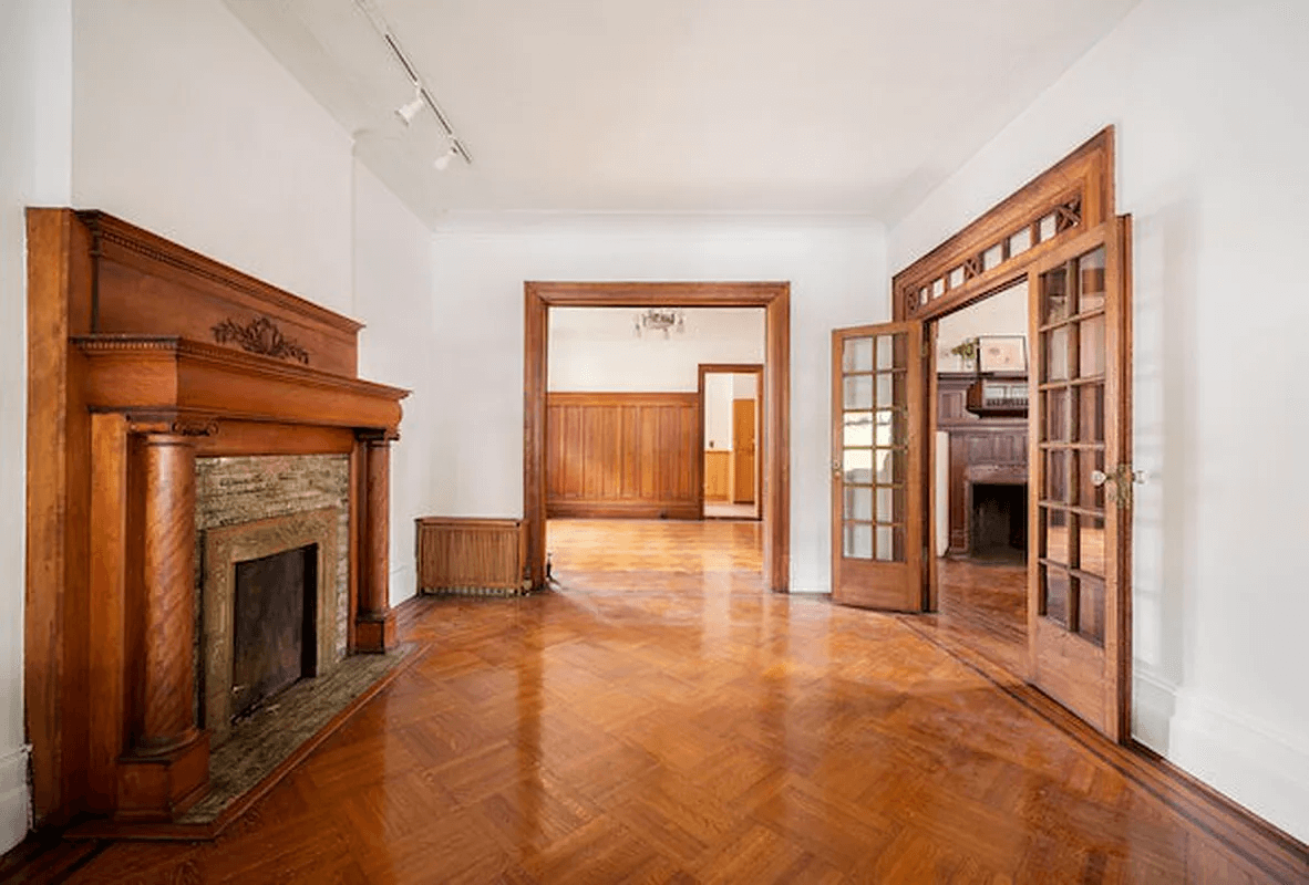 parlor with wood mantel and french doors