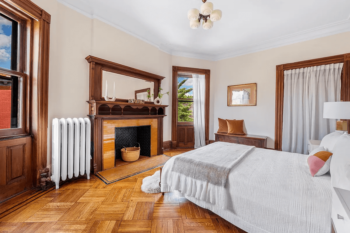 bedroom with two windows and a mantel