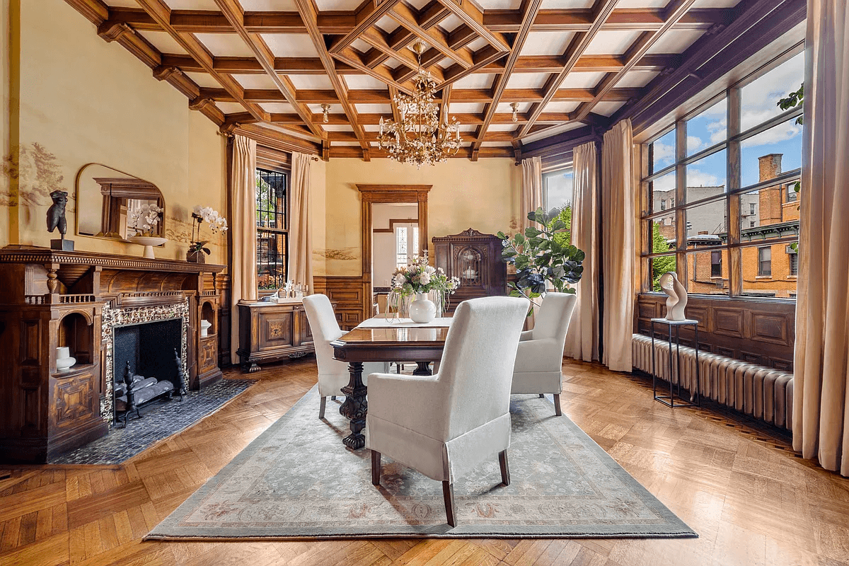 dining room with mantel and coffered ceiling