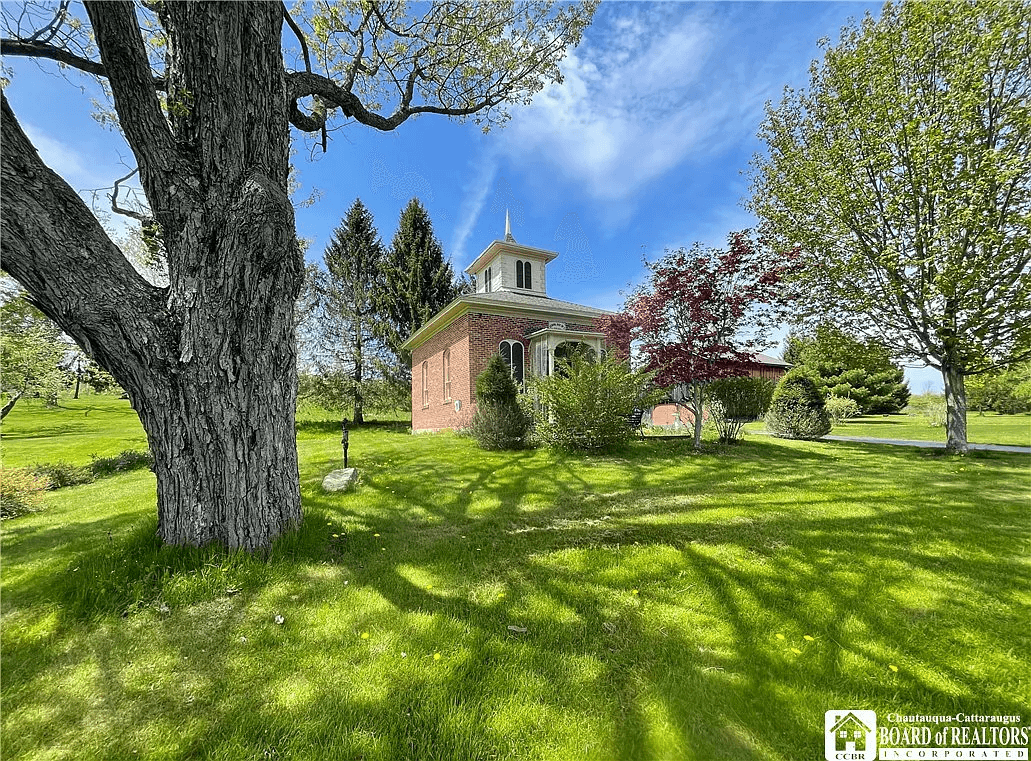 exterior of brick schoolhouse with cupola