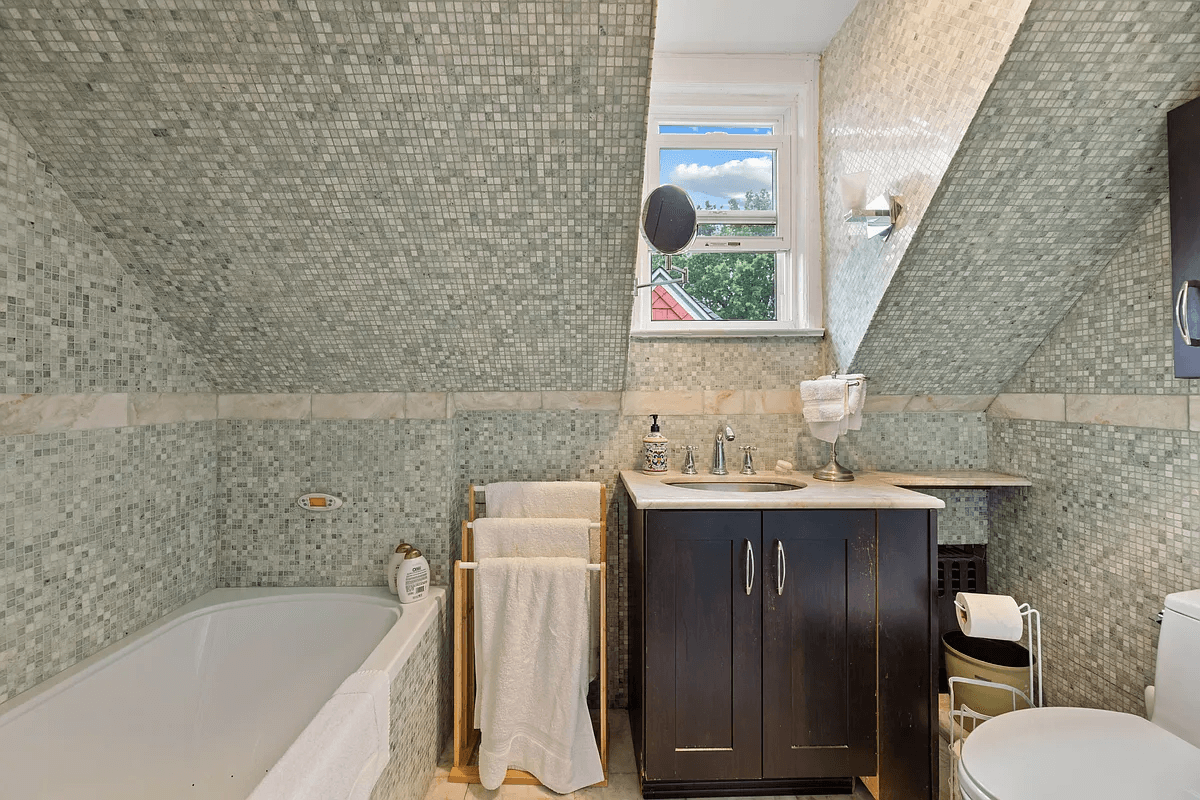 bathroom with sage green mosaic tile walls