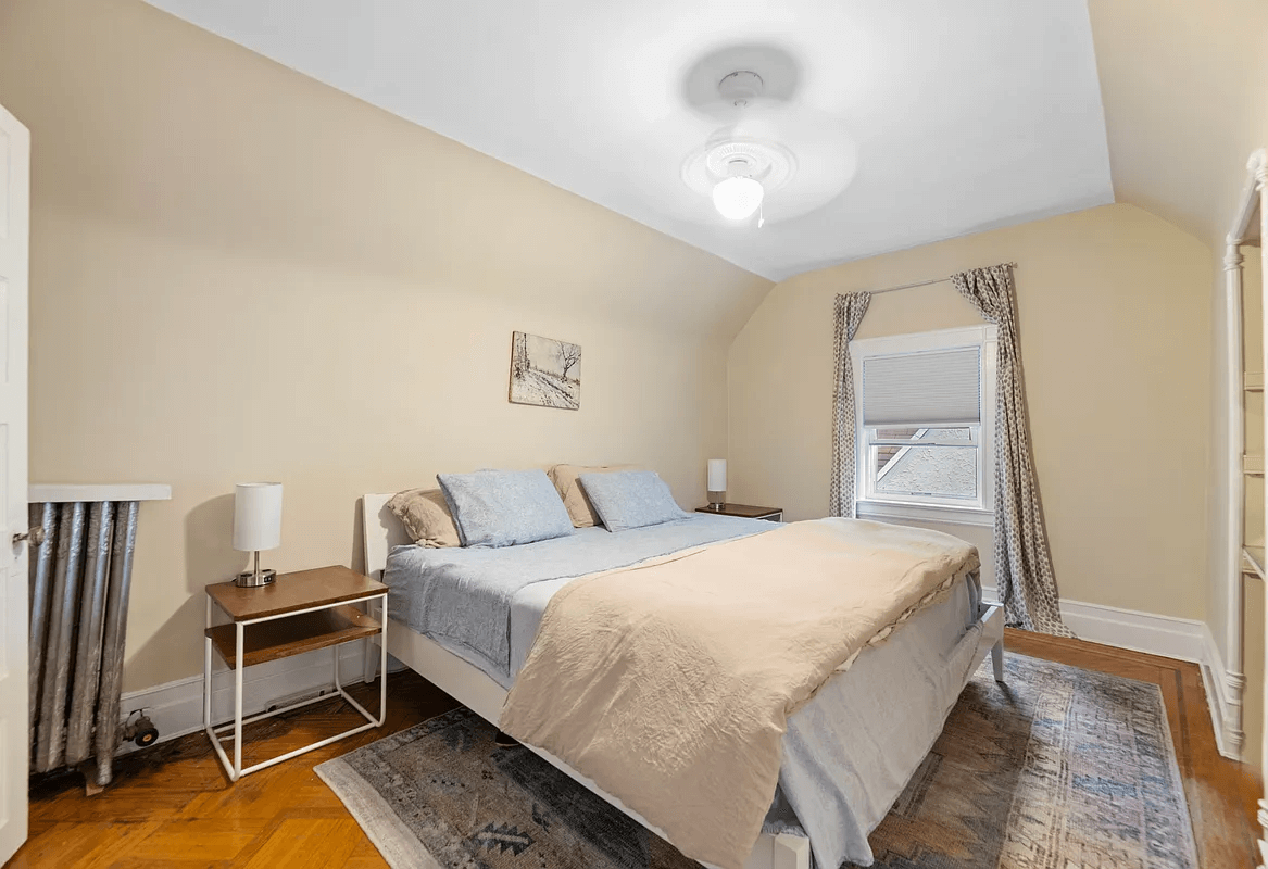 bedroom with tan walls and wood floors