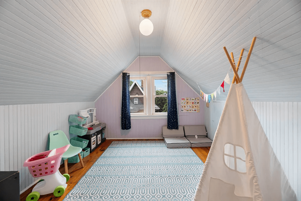 top floor bedroom with beadboard and angled ceiling