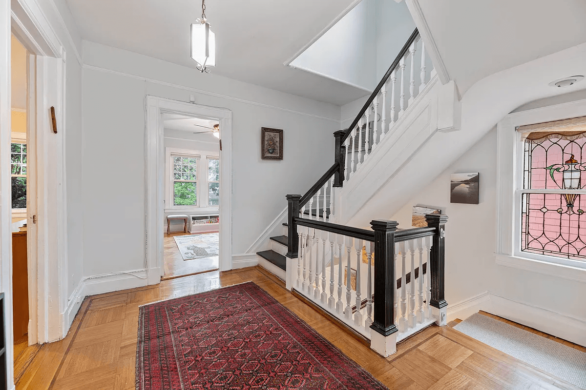 central stair with stained glass window on landing