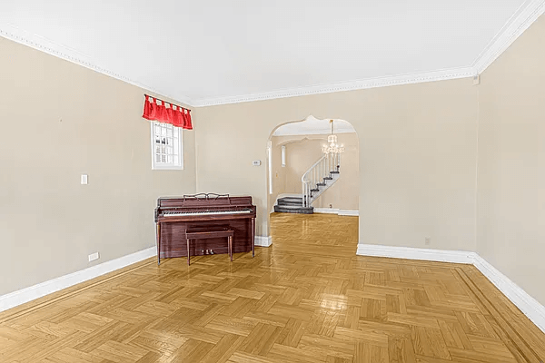 living room with an arched doorway to dining room