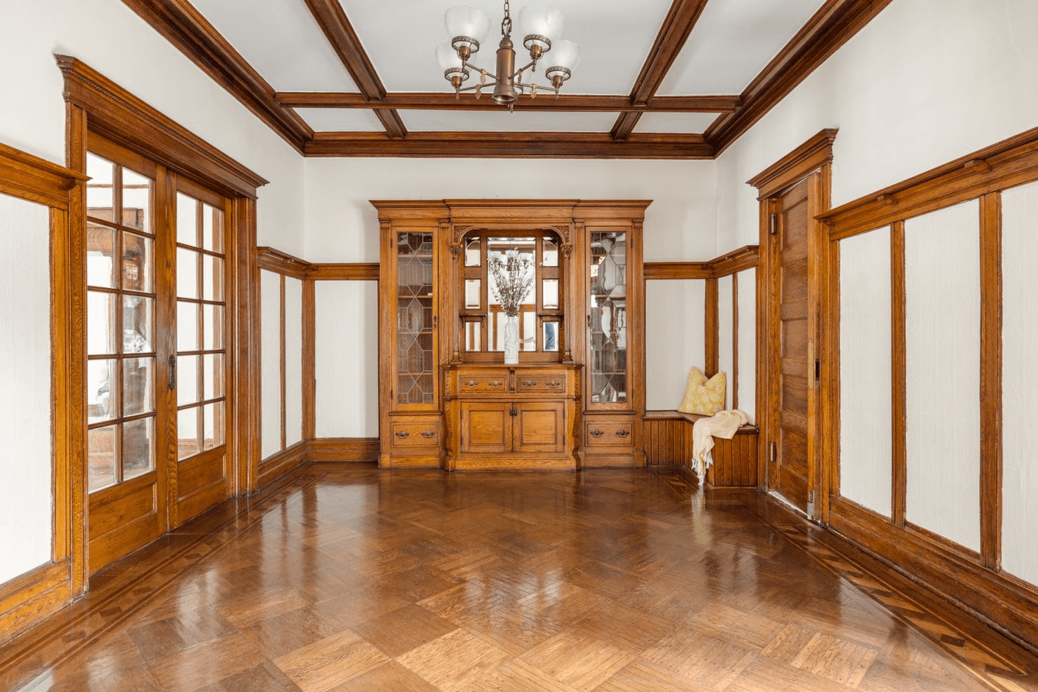 dining room with beamed ceiling and a built-in china cabinet