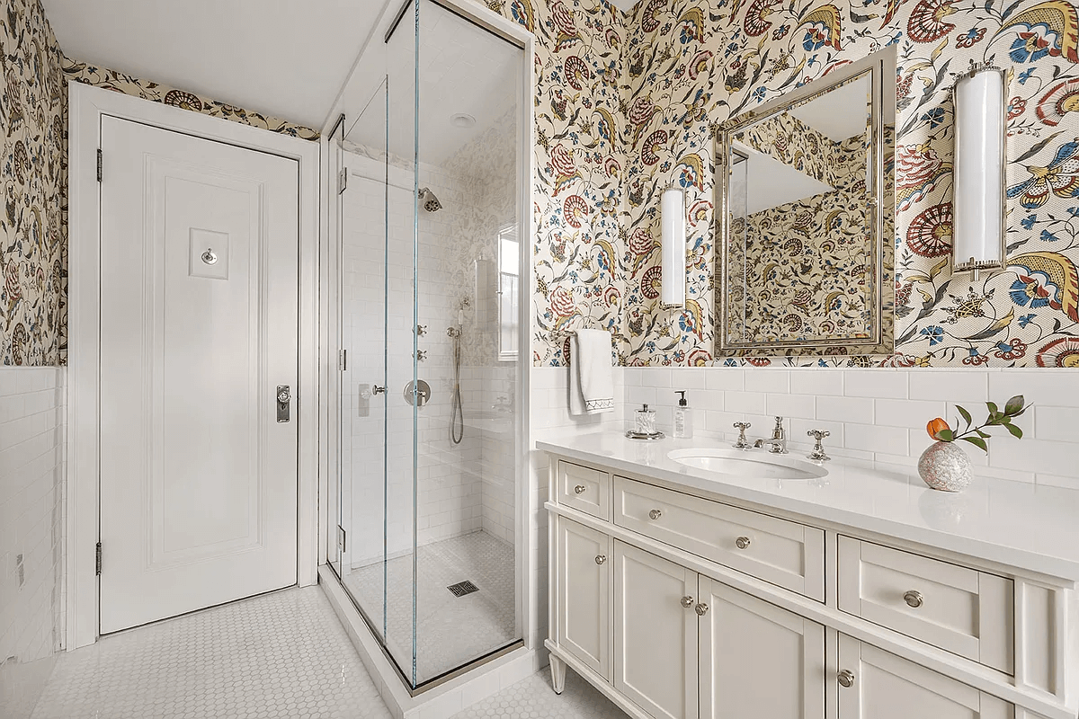 bathroom with corner shower and a white vanity