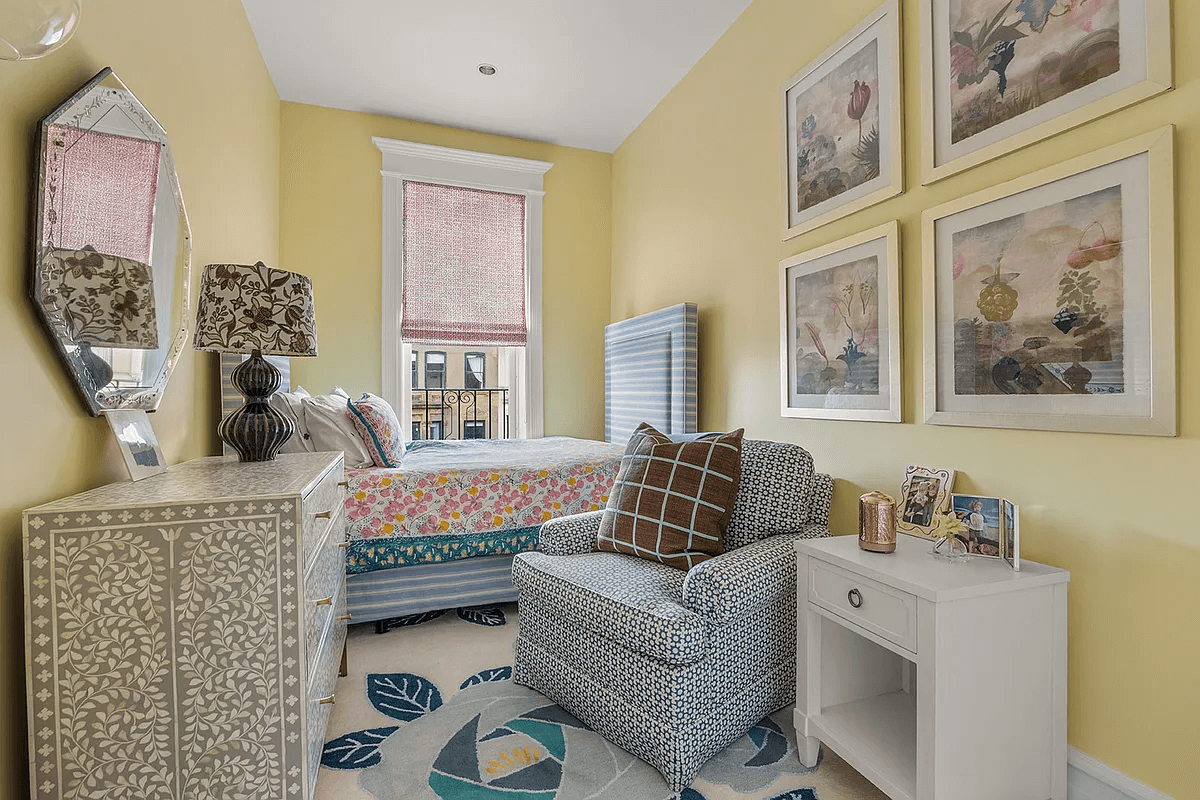 narrow bedroom with yellow walls