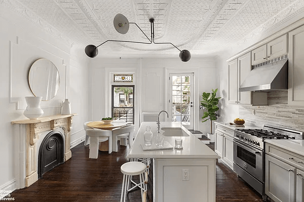 kitchen with marble mantel and white cabinets