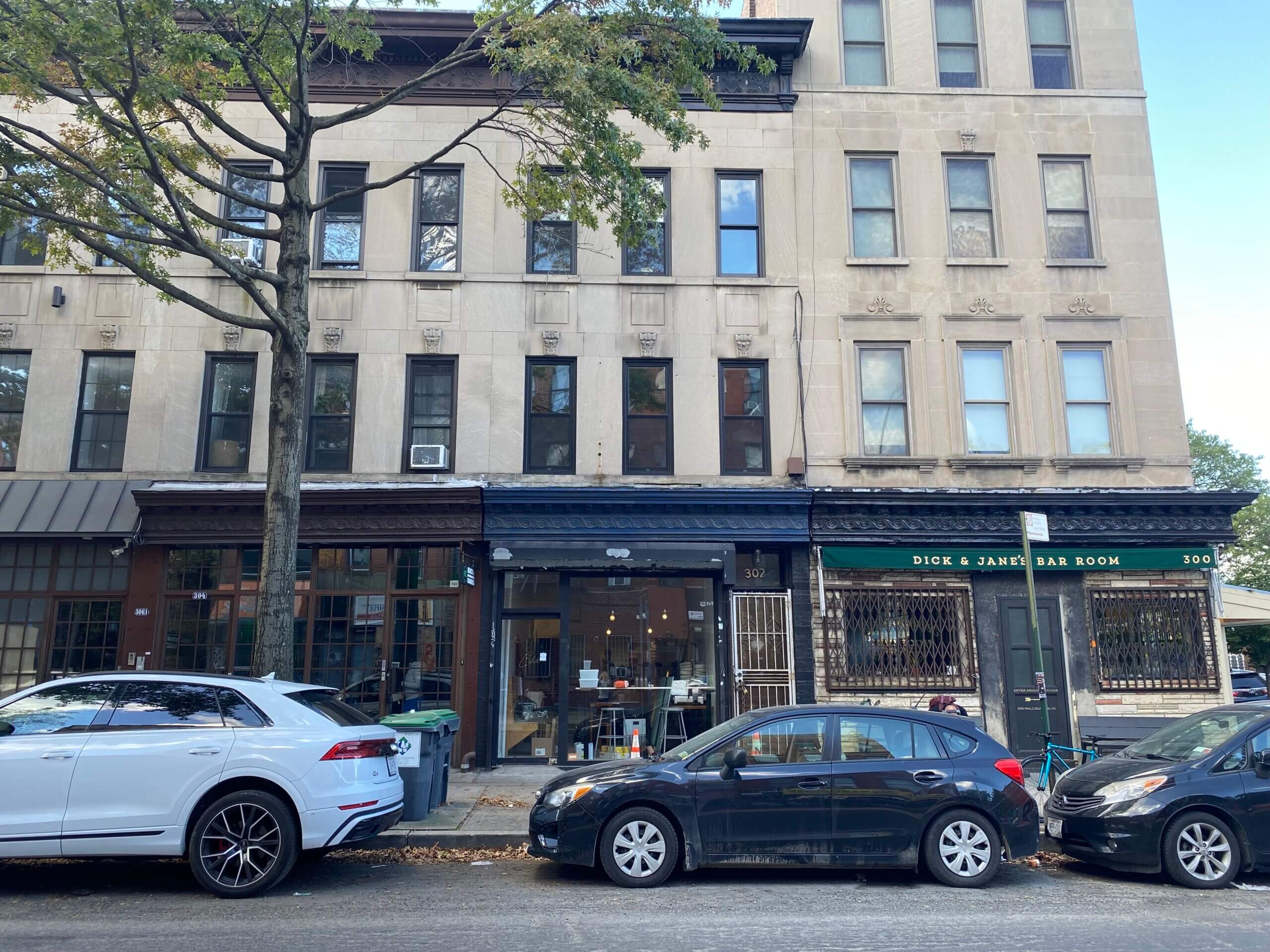 row of stone buildings with storefronts including che