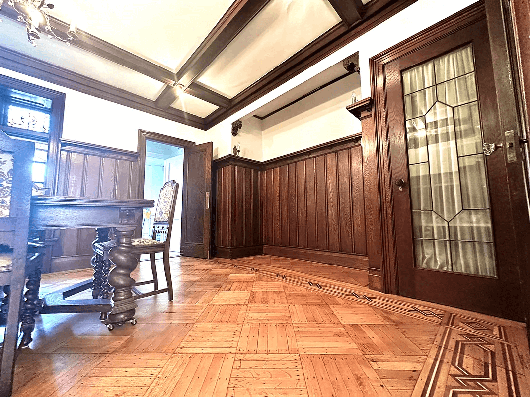 dining room with coffered ceiling and wainscoting