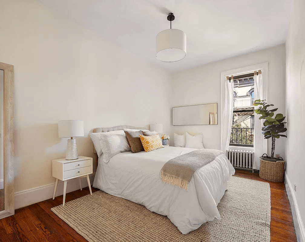 bedroom with wood floor and one window