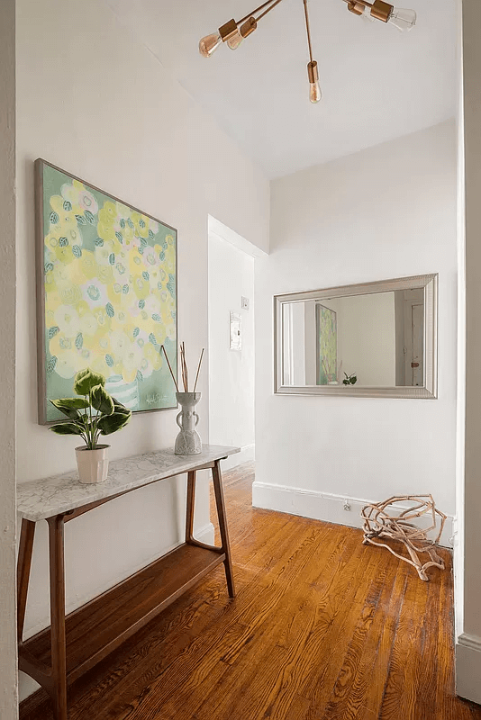 hallway with wood floors and white walls