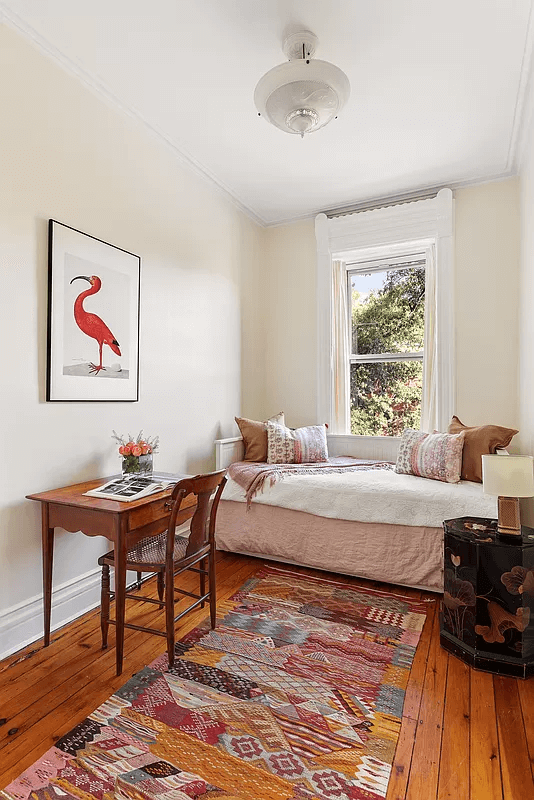 narrow bedroom with wood floor