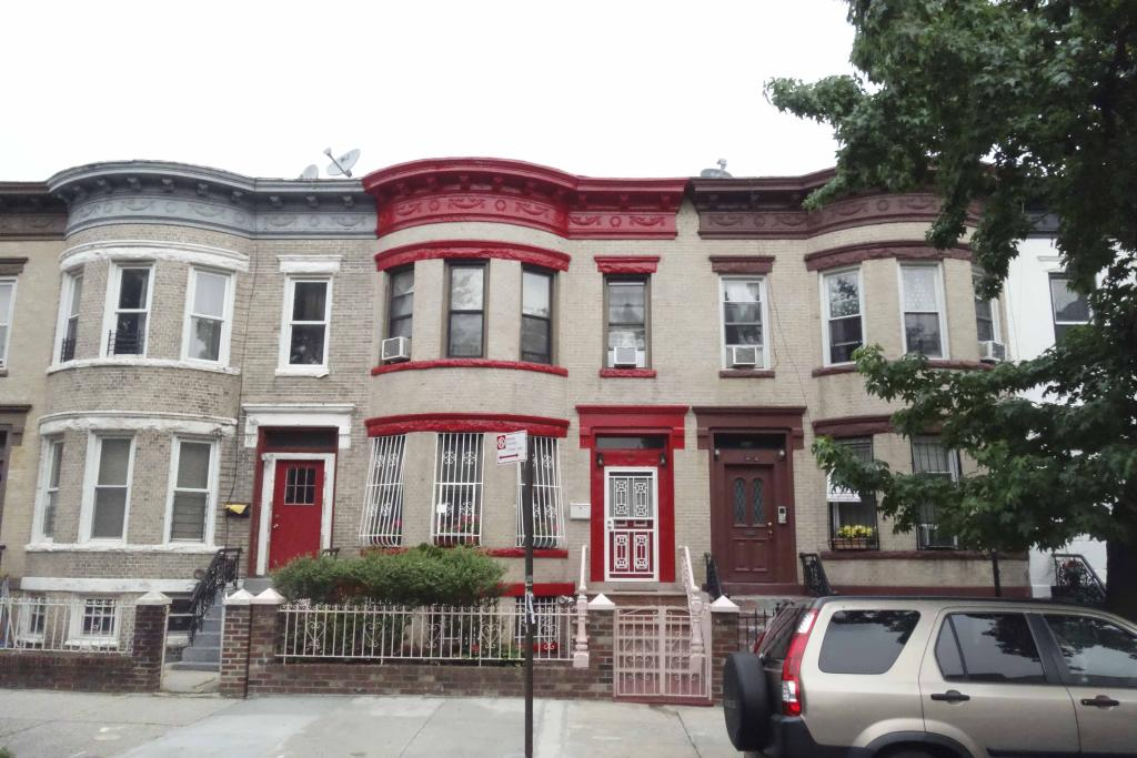 row of bow fronted pale brick row houses