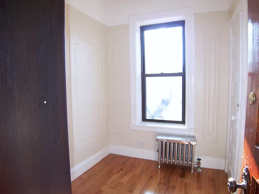 bedroom with wall moldings