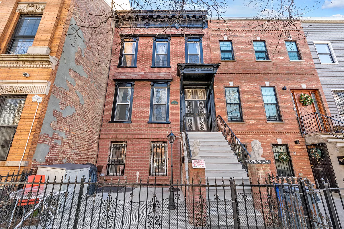 brick row house with wooden door hood