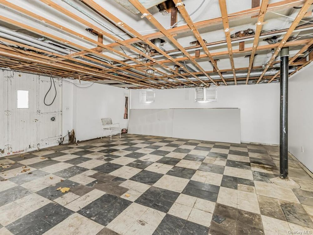 basement with black and white checkered tile floor