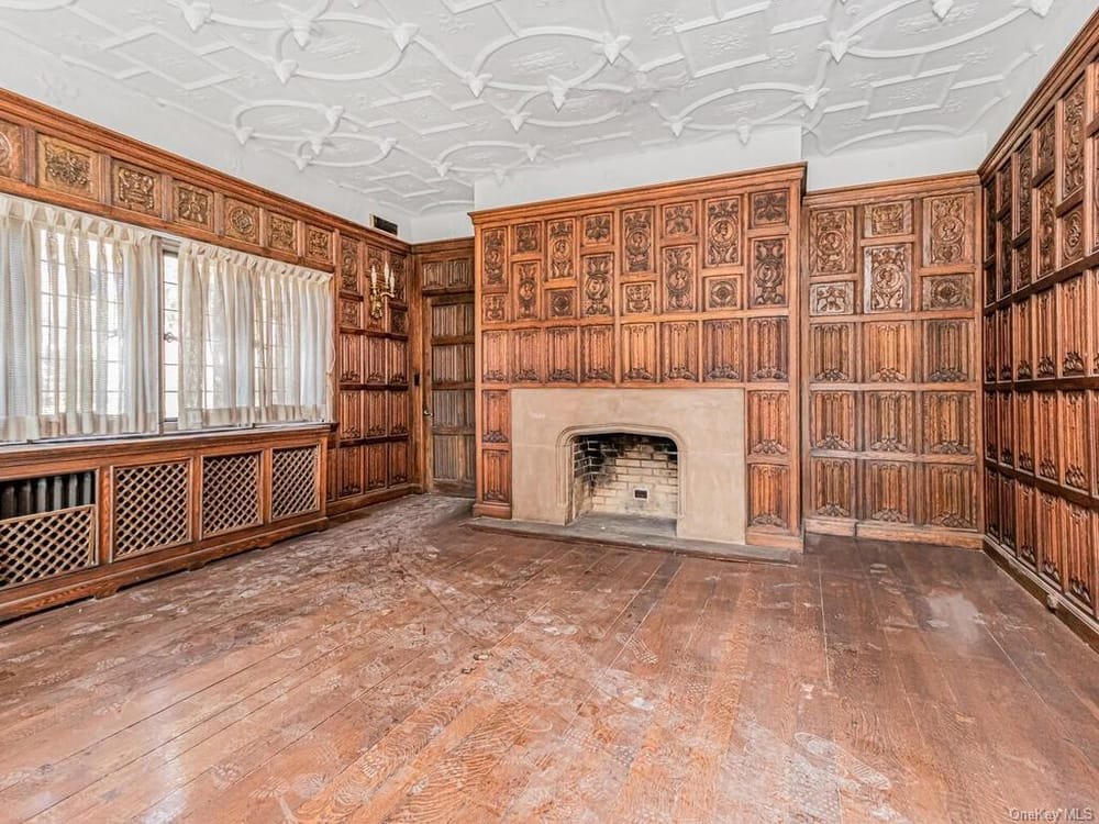 dining room with plaster ceiling and linenfold paneling on walls