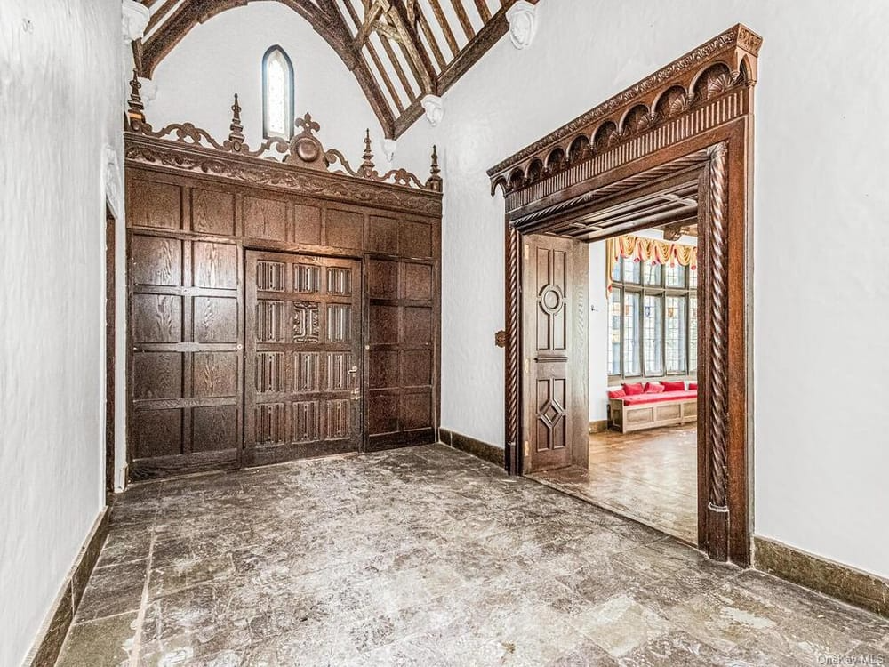 entry with stone floor and wood surround to living room