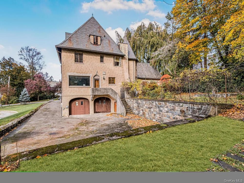 exterior with view of rear entrance and garage below