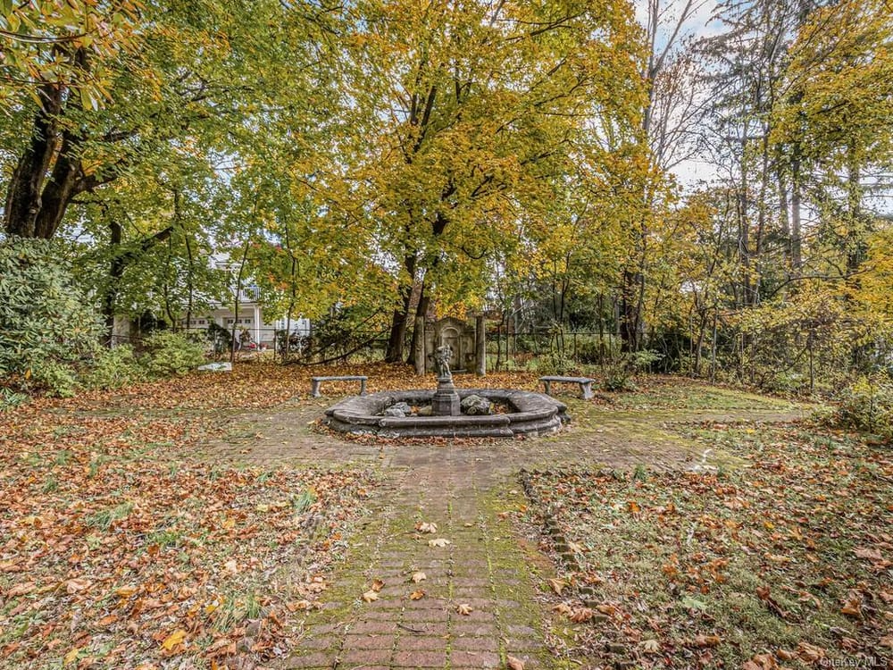 brick path to pond and stone benches