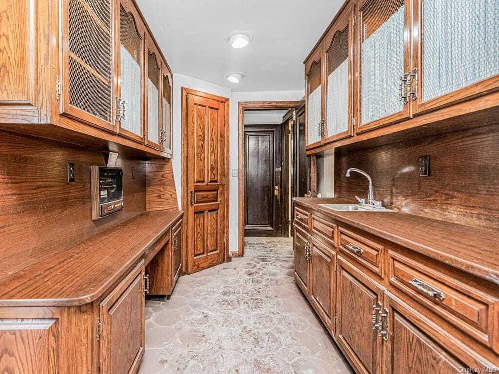 kitchen pantry with sink and wood cabinets