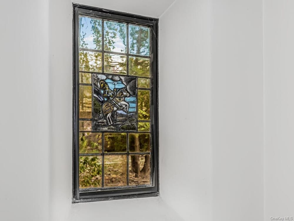 a stained glass window with a knight on a horse