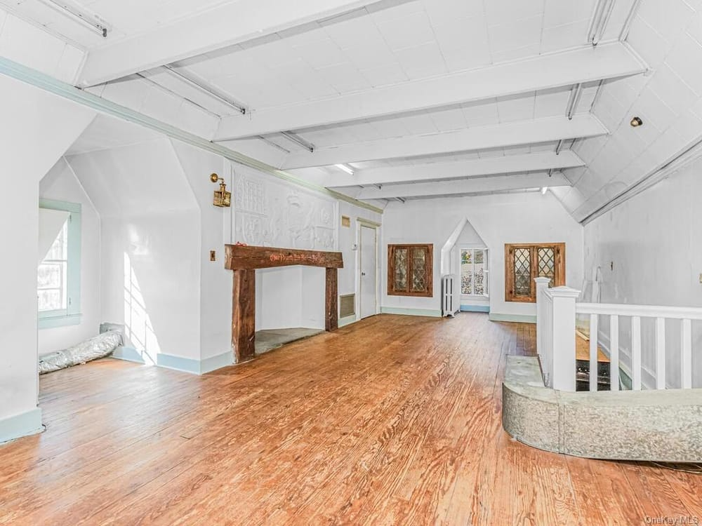 top floor room with wood mantel and plaster ornament