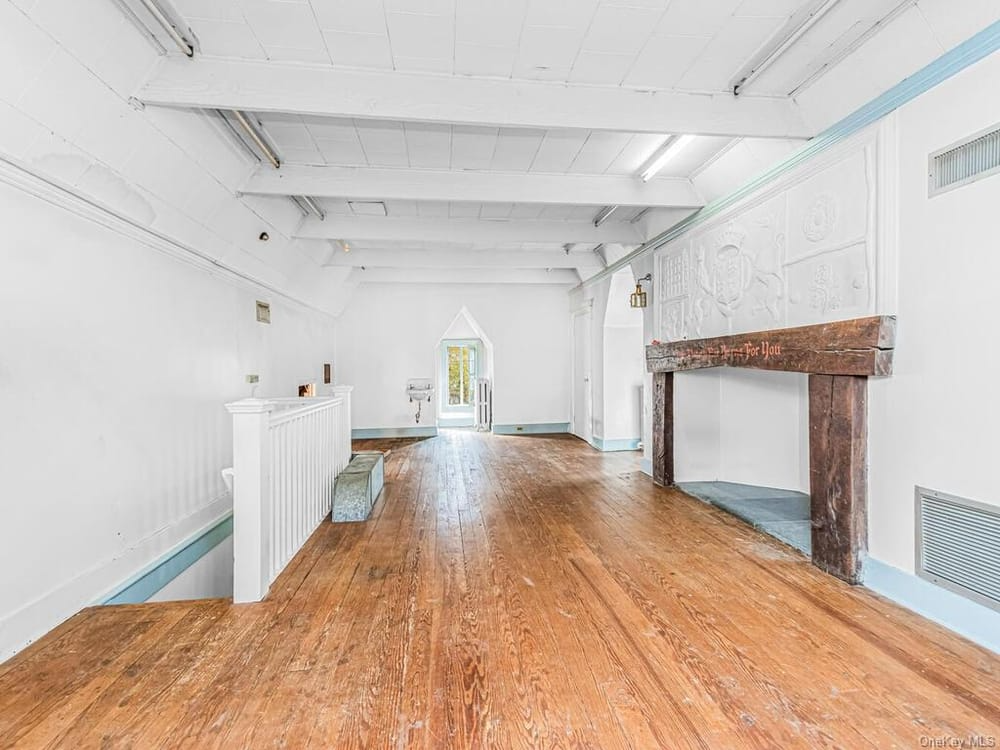 top floor room with wood mantel and plaster ornament