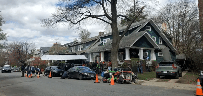 crew around the exterior of the blue house