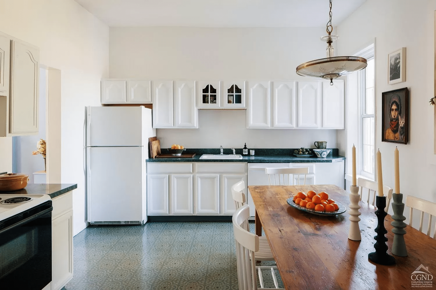 kitchen with white cabinets, tile floor and room for dining