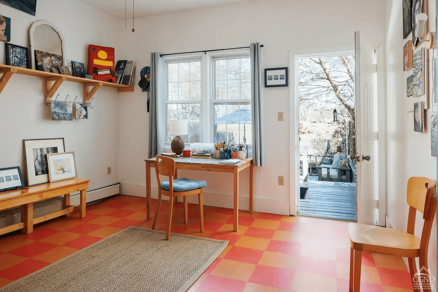 room with orange and yellow checkerboard floor with door to rear yard