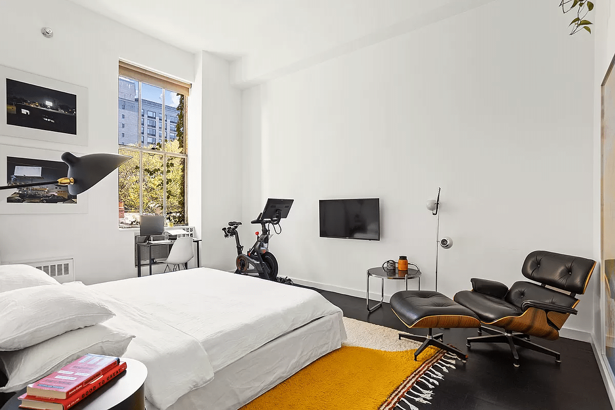 bedroom with white walls, dark floor