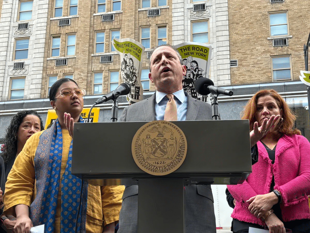 migrant shelter report - brad lander at a lectern