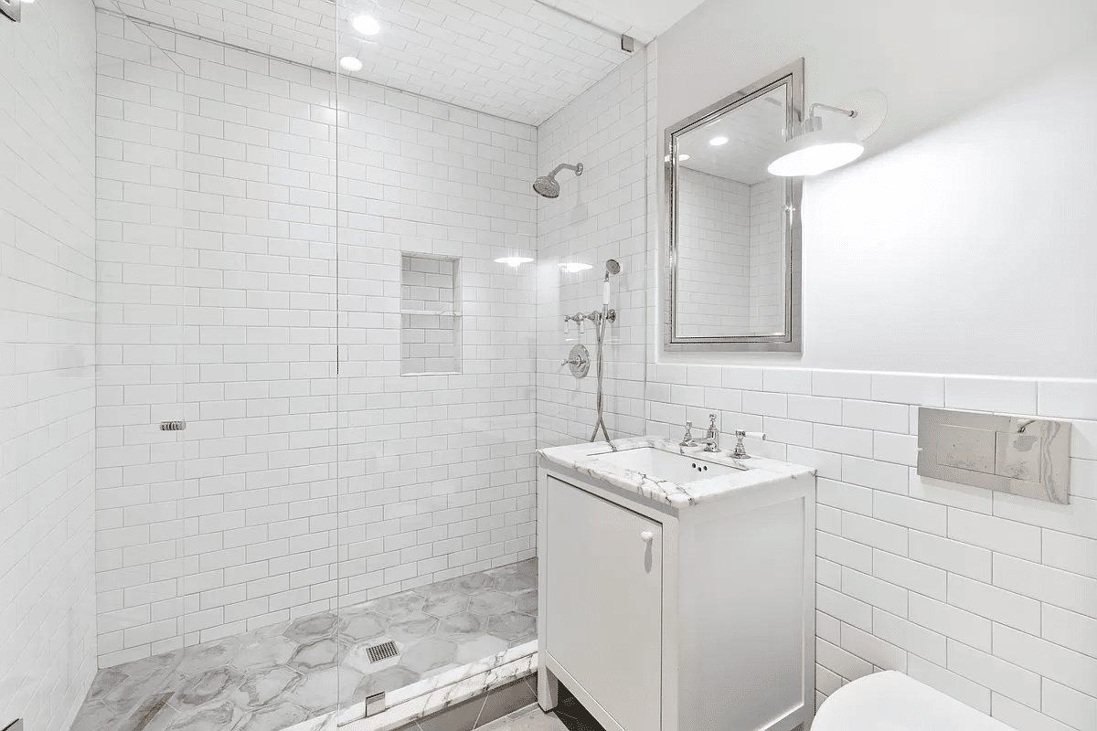 garden level bathroom with shower and white subway tile