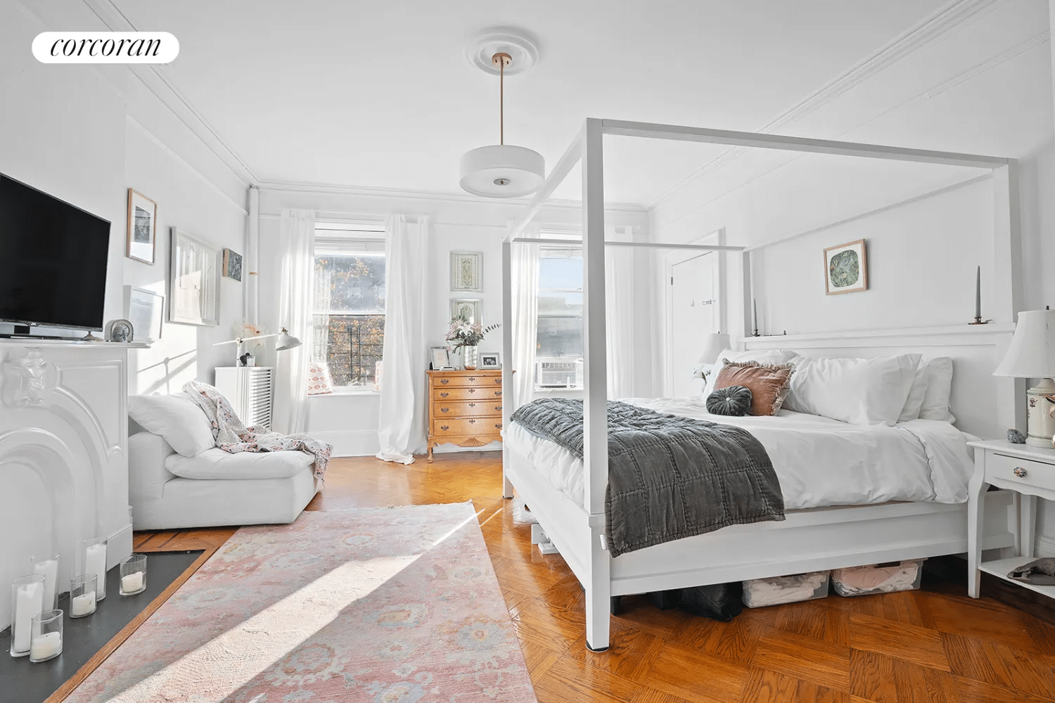 bedroom with mantel, wood floor