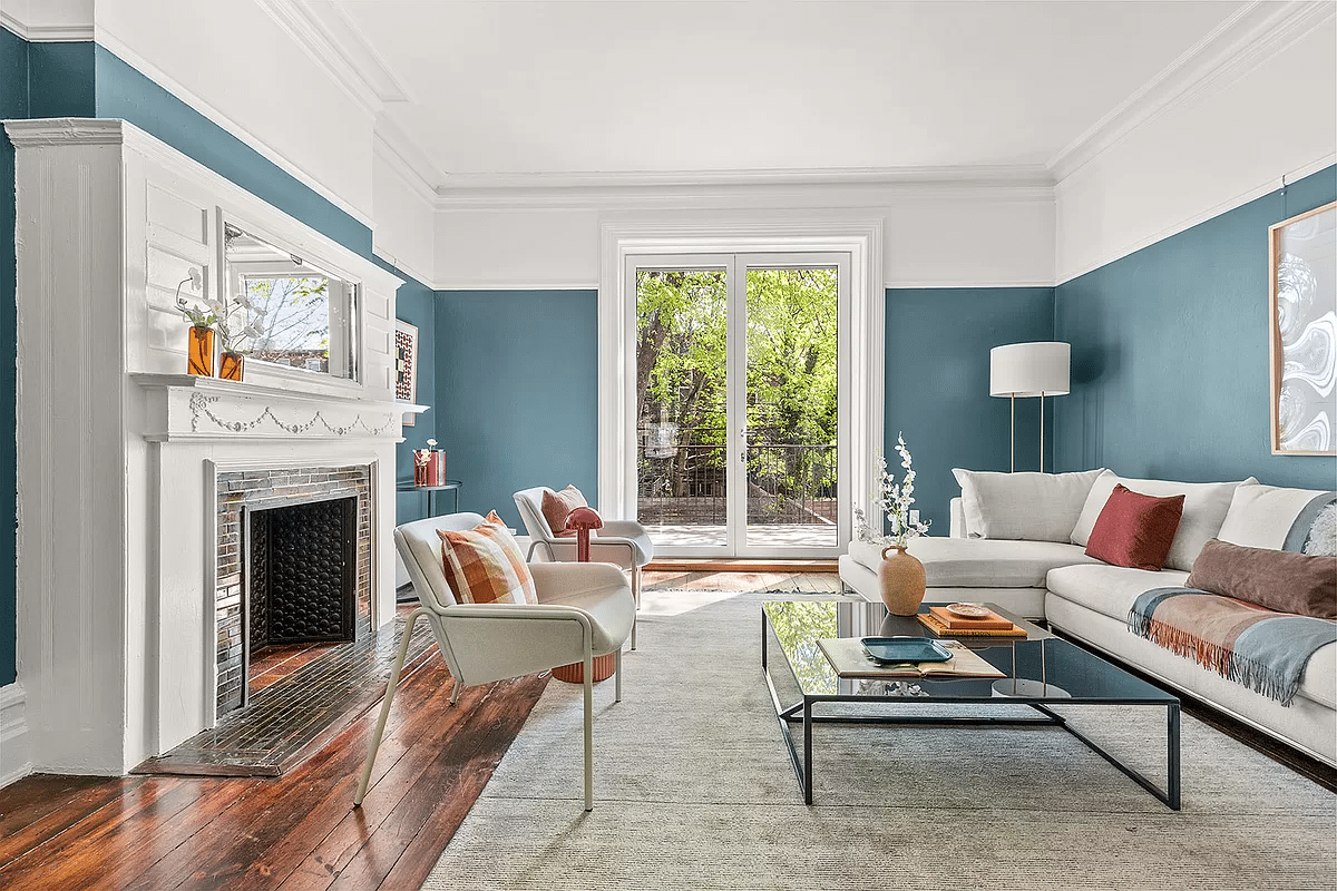 parlor with blue walls and a fireplace