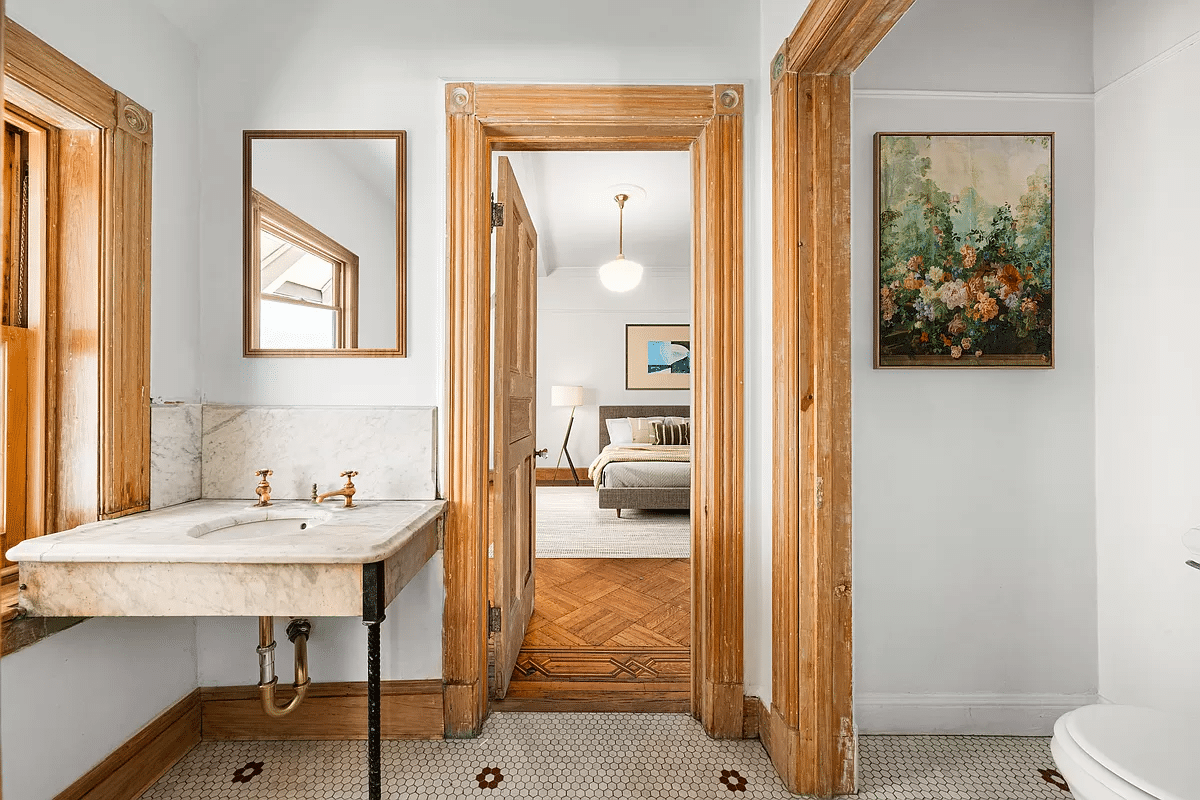 marble sink with view into staged bedroom