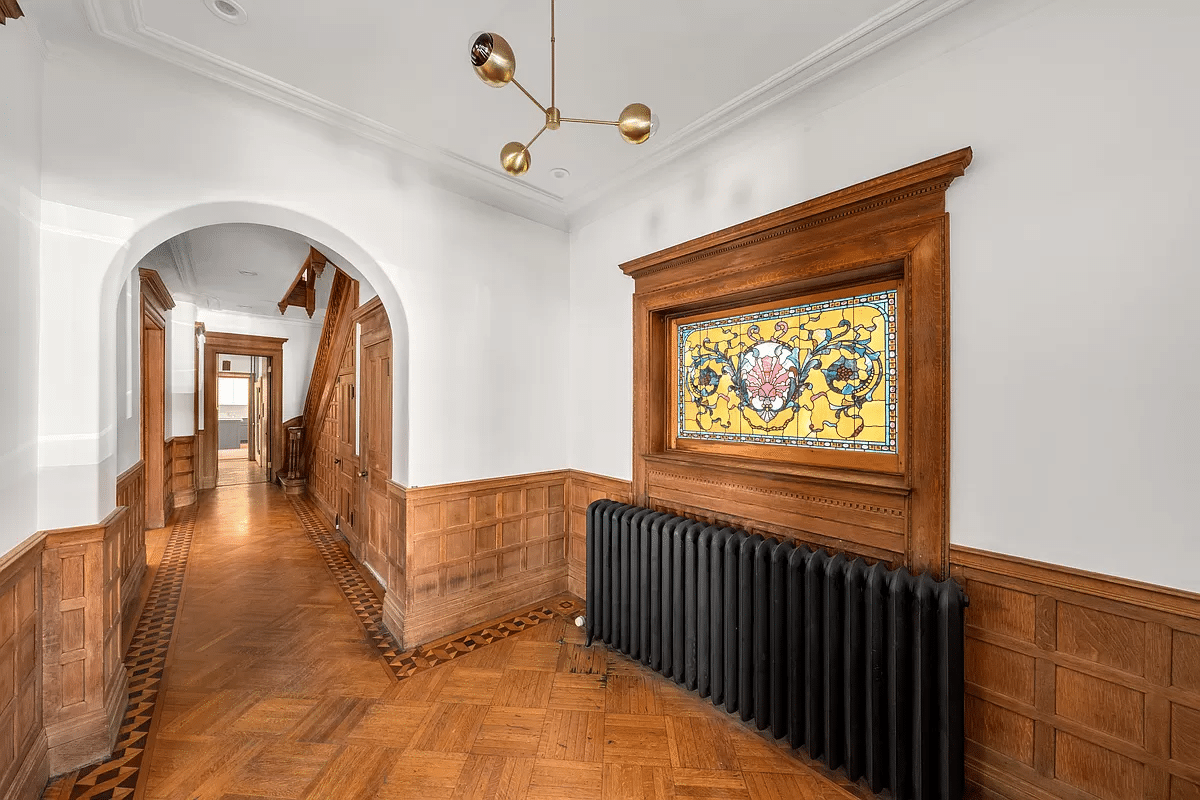 hall with stained glass window and wainscoting