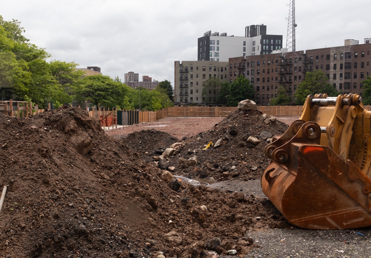 rubble behind construction fence